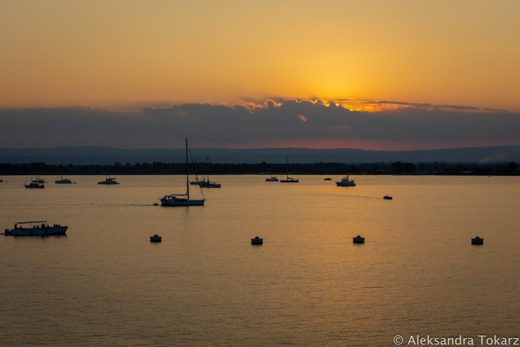 Syracuse anchorage with boats anchored, sunset